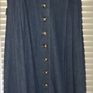 Sleeveless blue denim dress with flared bottom.